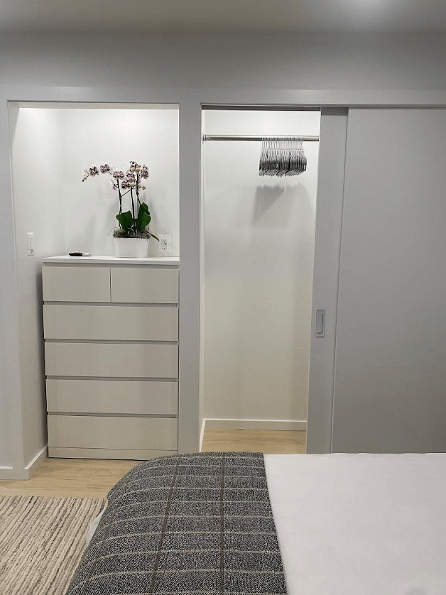 6-Drawer Dresser Alcove with Lighting, Next to Floor to Ceiling Double Closet with Interior Lighting, Great for Larger and Longer Items.
