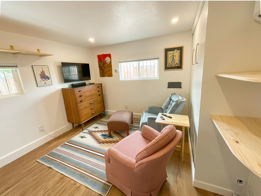 Casita with Murphy bed in the up position. Both armchairs rock and swivel.