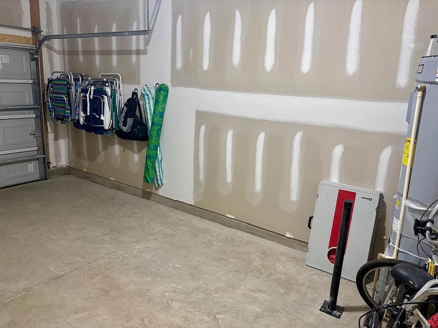 Garage with beach chairs, beach umbrellas, corn hole set, two bikes, not much room for a car though.