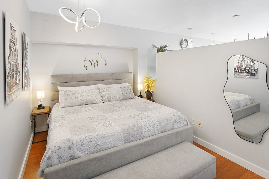Bedroom with King Bed Plush linens and calming dcor.