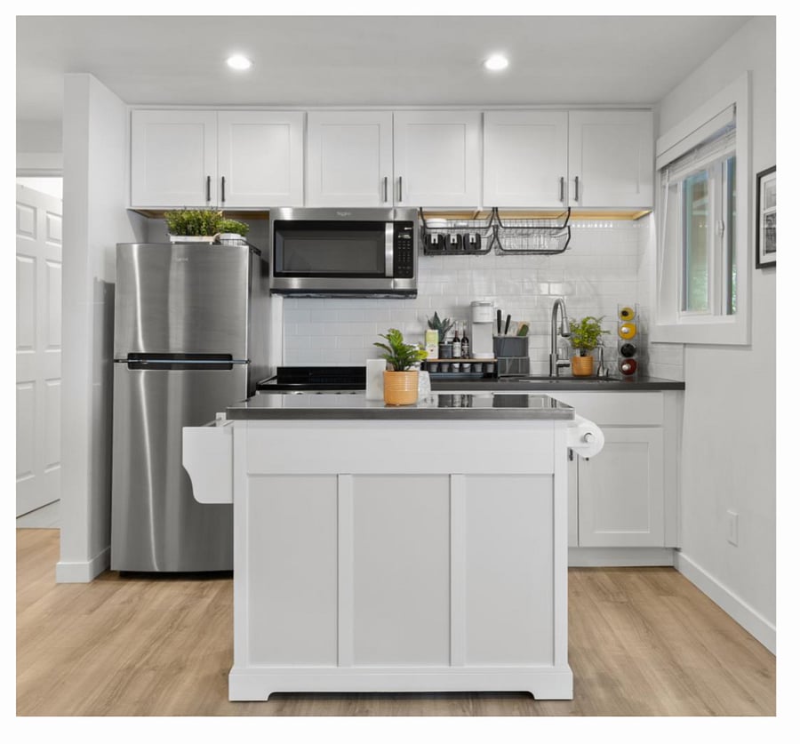 Basic kitchen and cleaning essentials are available in their designated spots for easy access.