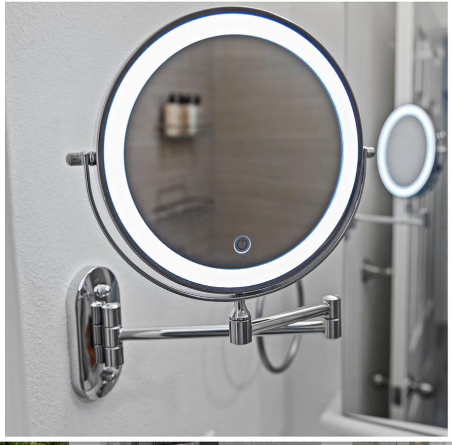 Lighted wall-mounted makeup mirror with magnification, dimmable settings, and full rotation.