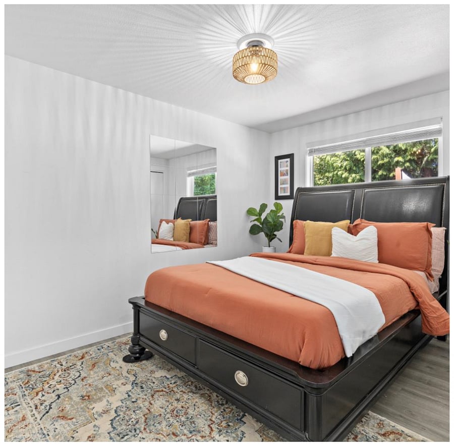 Master bedroom with faux wood blinds to create a darker, restful space.