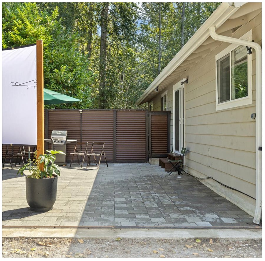Gated backyard opens to extra space that can serve as a third parking spot if needed.