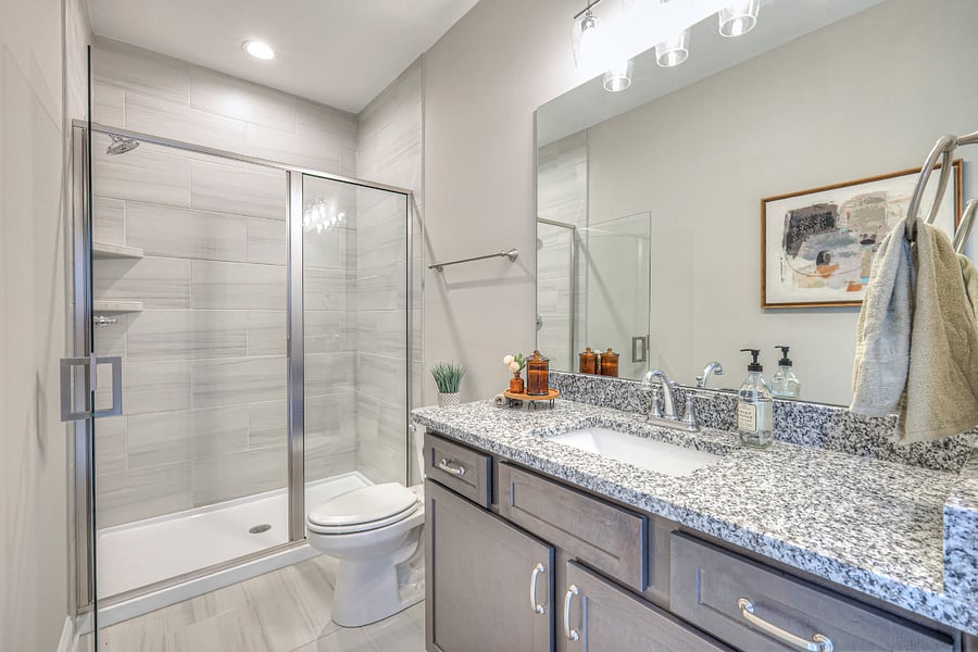 primary bath features a walk in shower and ample counter and storage space