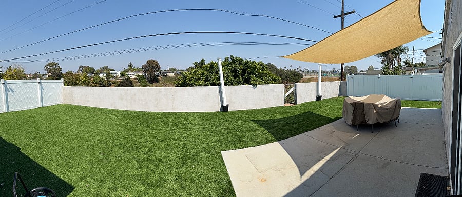 Backyard with covered patio overlooking canyon.
