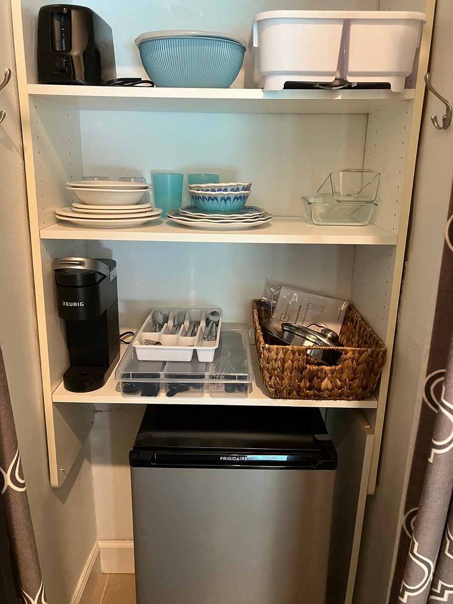 Kitchenette with refrigerator, toaster, Keurig, kitchenware, dinnerware, cookware, etc. 