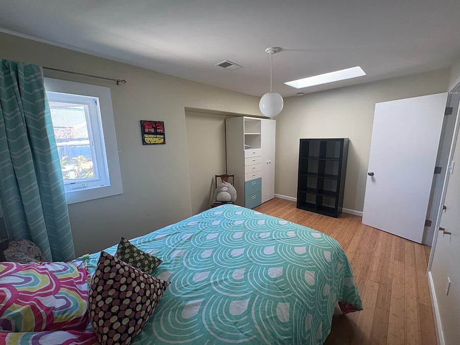 Larger bedroom with wardrobe.