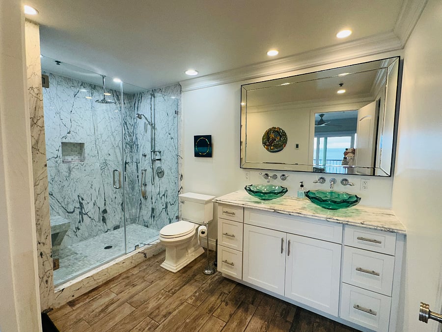 Master bedroom bathroom with rain shower and walk-in closet.
