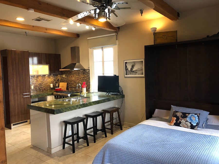 Looking at the kitchen you can see the built in refrigerator that matches the cabinet finishes. Glass tile backsplash, granite counter tops, stainless hood over the 
