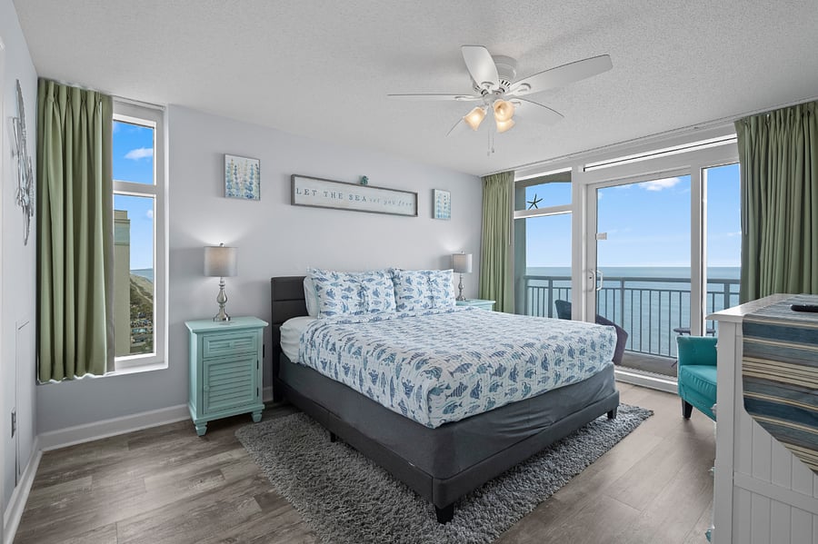 Master bedroom with king bed and access to balcony