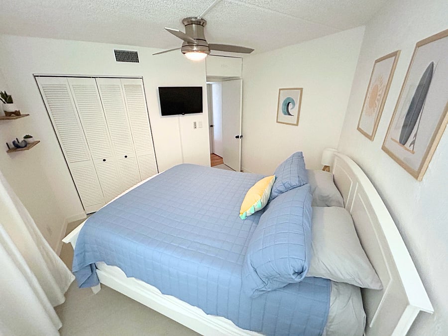 Bedroom 3 features a queen-sized bed, a roomy closet, a TV, and a ceiling fan. 