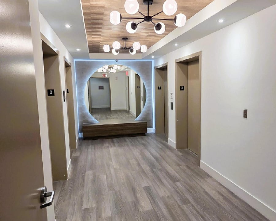 Modern & Secure Entry Designed for Peace of Mind Arrive to a clean, well-lit hallway with elevator access and clear emergency signage. Perfect for traveling professionals who value comfort, safety, and convenience.