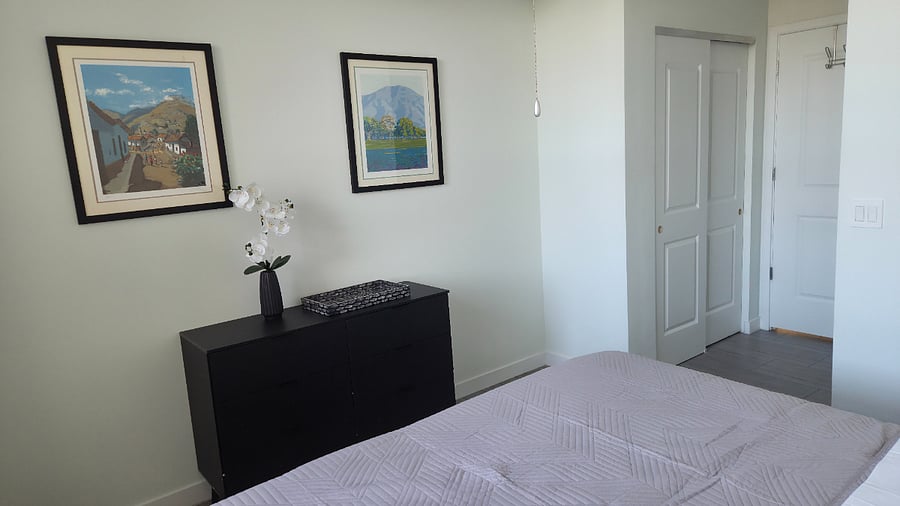 Rest Easy in a Peaceful, Art-Inspired Retreat Recharge in a quiet bedroom featuring soft tones, elegant wall art, and organized storage. Designed for comfort and calm after long shifts.