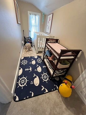 2nd floor bonus room set up as a nursery. This room can be customized as a reading room, play room or simply for storage depending on your needs.