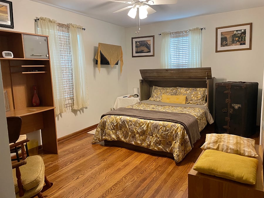 Yellow bedroom with TV.