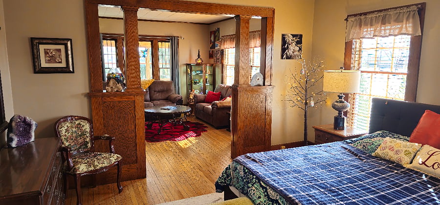 Large Downstairs bedroom featuring King-Size Bed with Living room/Den area attached.