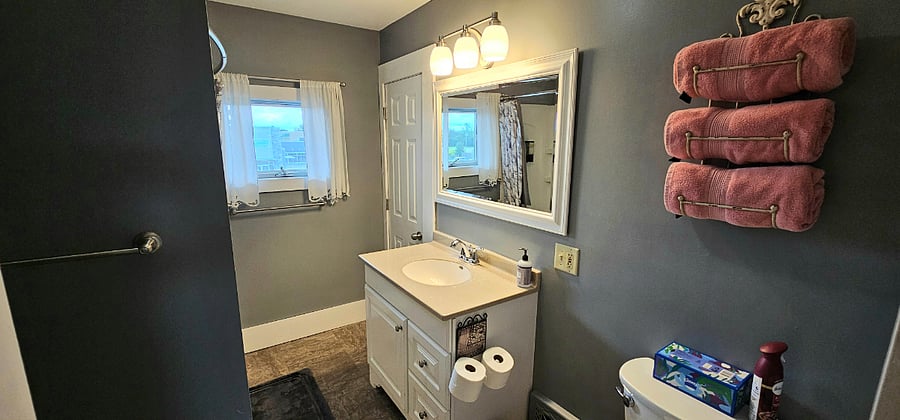 Upstairs Full Bathroom featuring tub and shower.