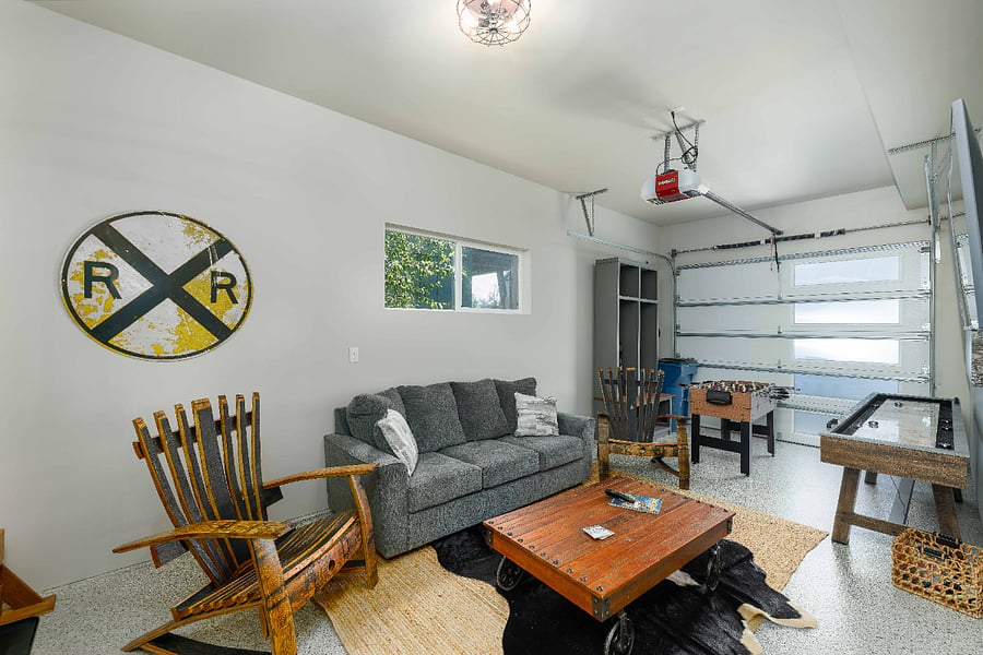 Converted second living space and game room with storage cubbies and smart tv.