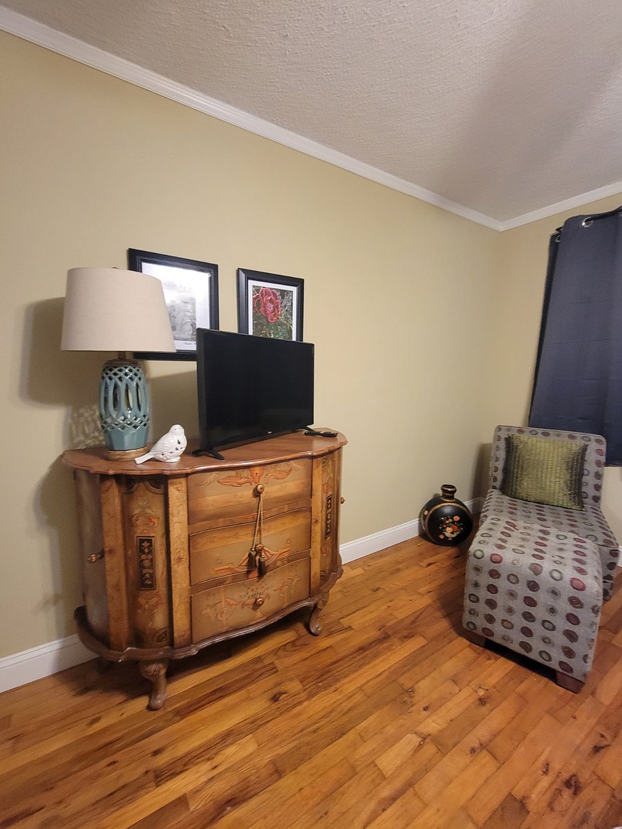 Large chest with side cabinets on either side and 32 inch LG Smart TV.