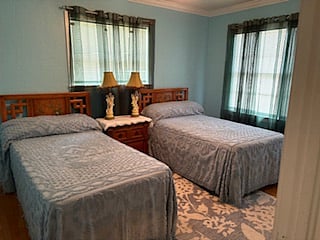Secondary bedroom has twin beds, a shared nightstand and a big closet.