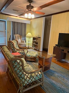 Living area boasts beachy rattan furniture and smart TV. 