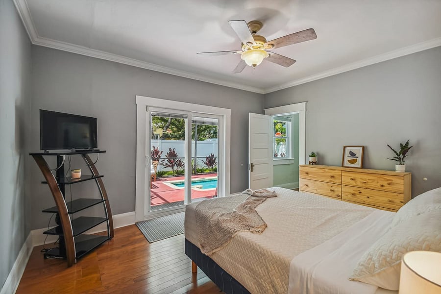 Primary bedroom opens onto the pool and includes a full-size dresser