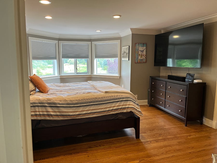 Master bedroom with TV & master bathroom. View