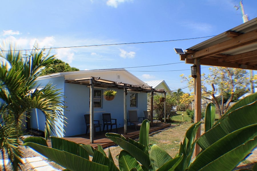 Fully fenced backyard with chairs under the Pergola 