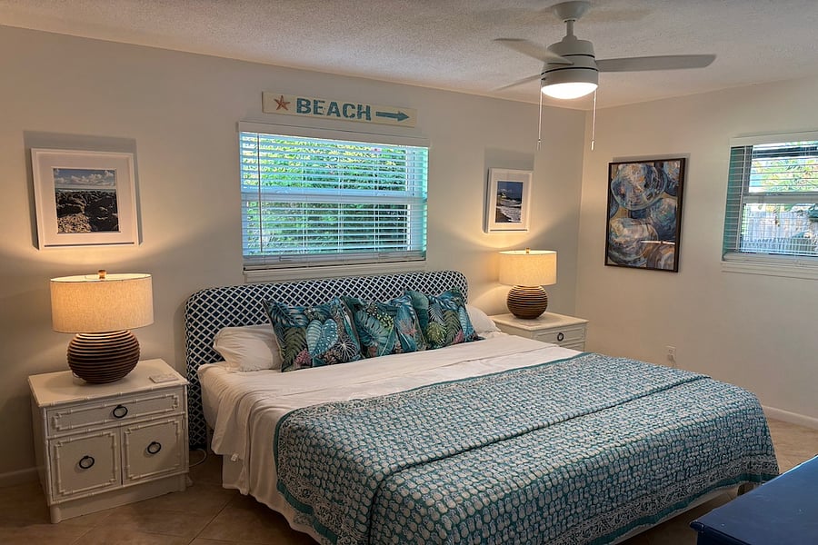 King Bedroom with full size dresser, closet and ceiling fan. Darkening blinds have been added.