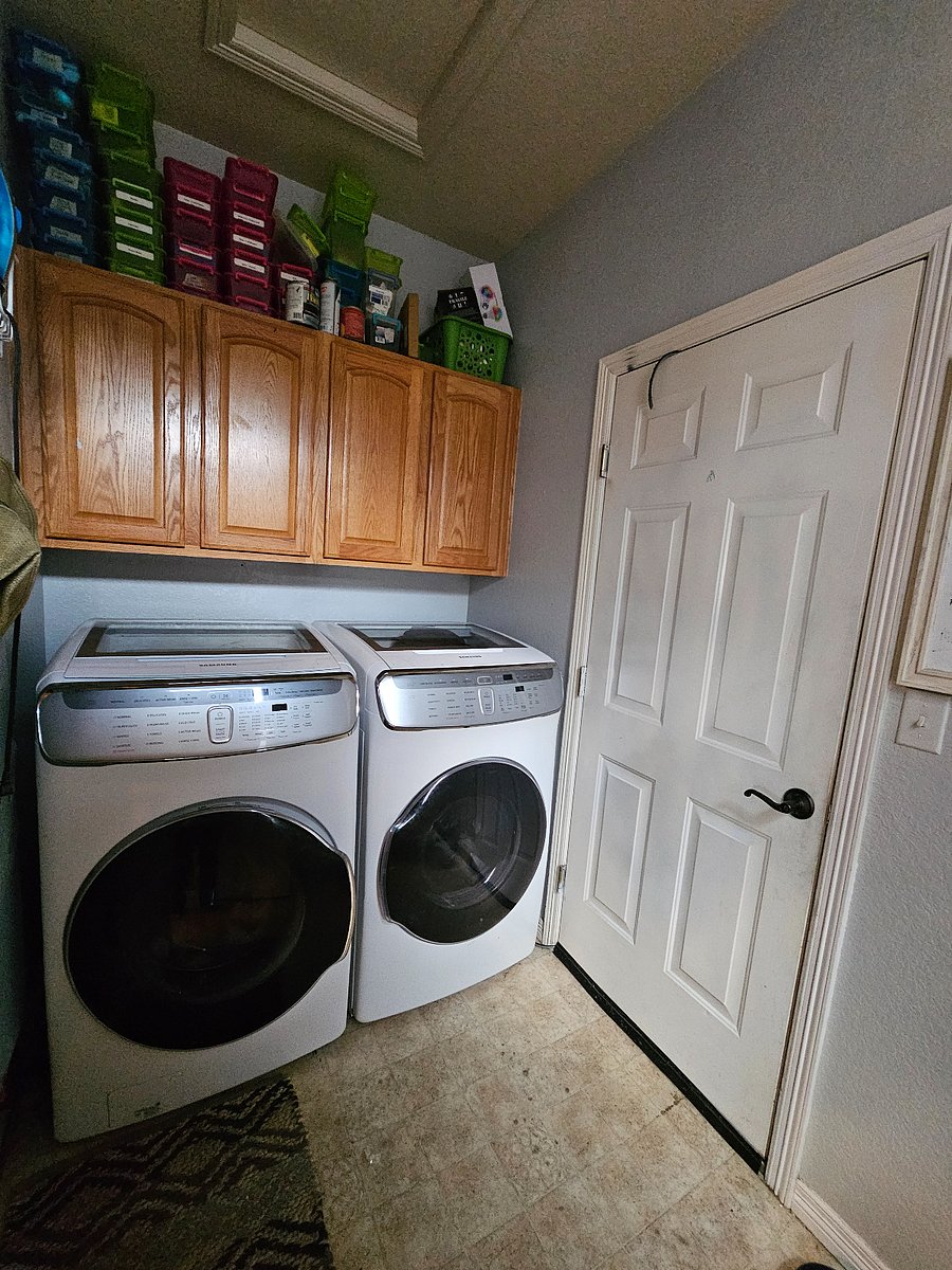 Washer & dryer with a top 'small' load & 'delicates' feature (can run 2 loads at one time). Door to right is door to garage.  1 space in an oversizrd 2 car garage. 