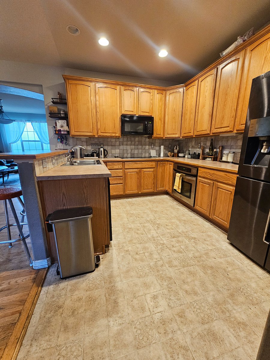 Kitchen. View from walkway, near powder bathroom & door to private patio.