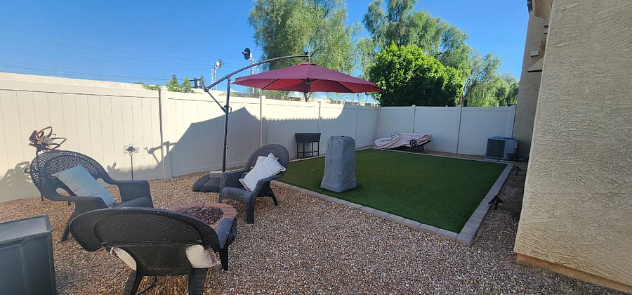 Backyard has artificial grass.