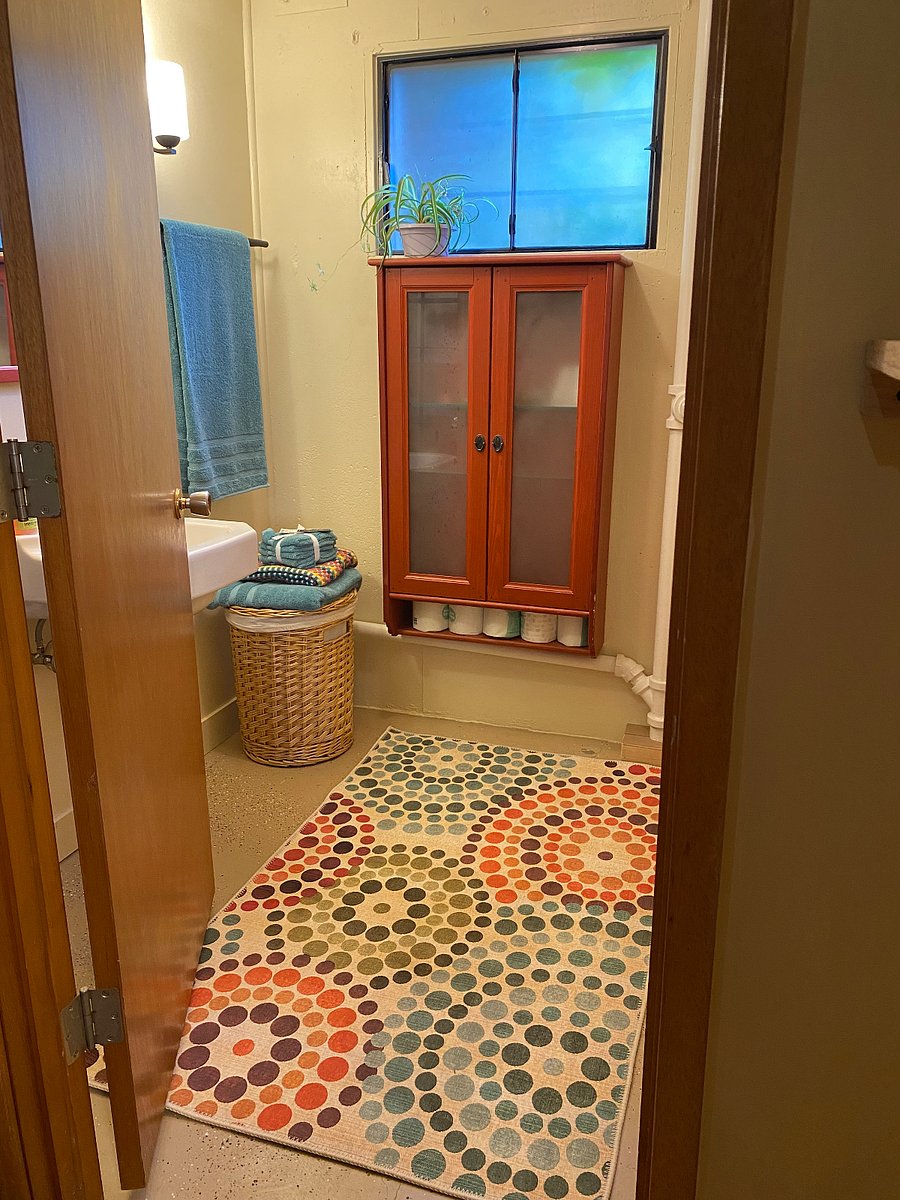 Roomy bathroom. convenient shelving and Cabinet for all your essentials. Hamper basket.