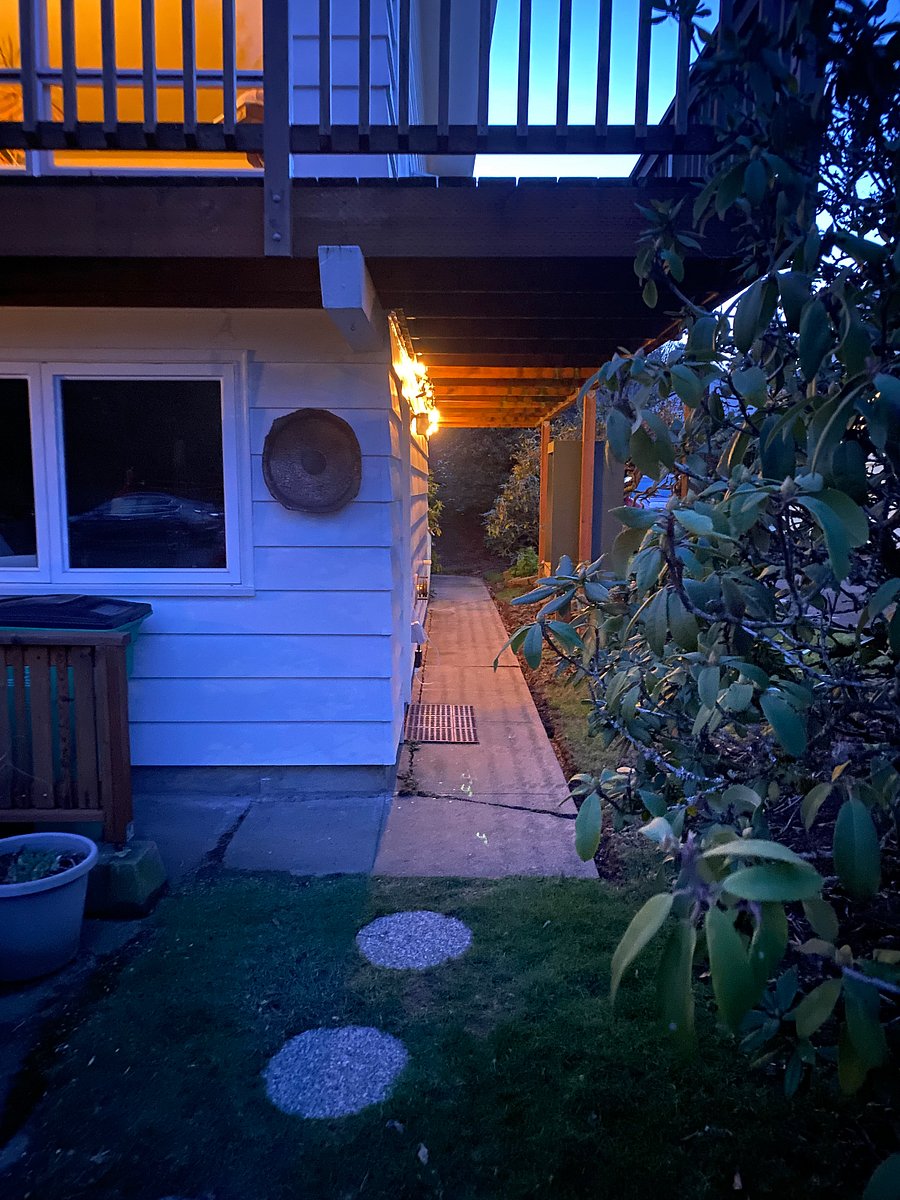 Entrance path lighted at night.