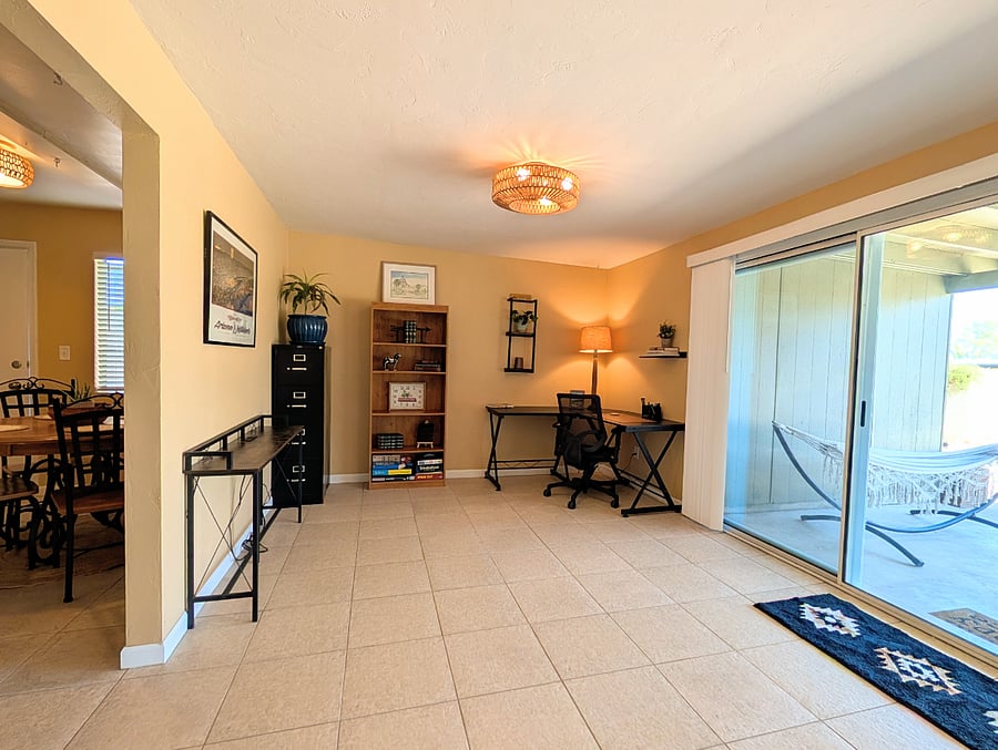 Office that opens up to the patio through a sliding door, and also connects to the dine-in kitchen and laundry room