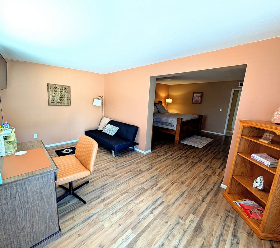 Private office space and futon/TV off of primary bedroom