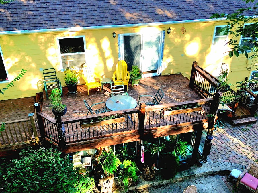Spacious 12'x20' back deck with seating and greenery, great for outdoor dining or unwinding after work.