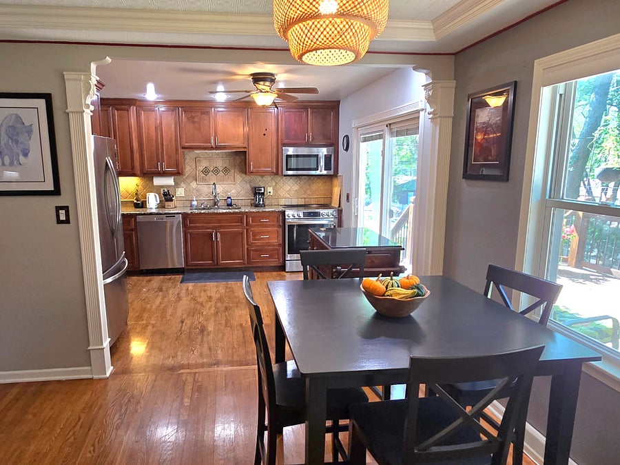 Fully equipped kitchen with stainless appliances, ample storage, and view toward the back deck.