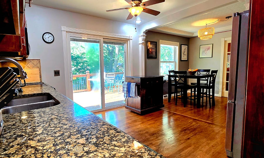 Bright kitchen with view to dining room and back deck easy flow for meals and entertaining.
