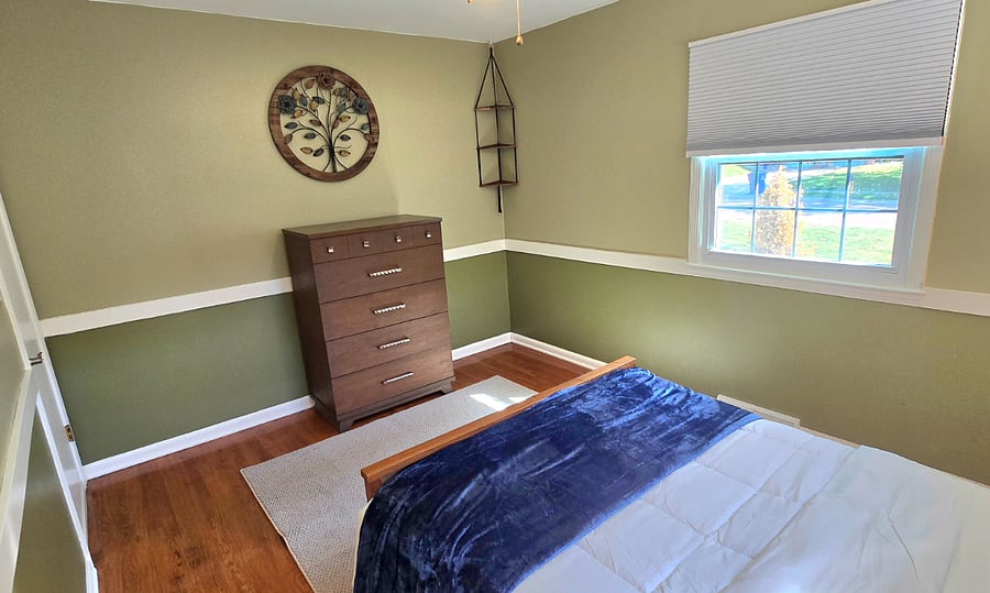 Second bedroom view of front window with blackout shades.