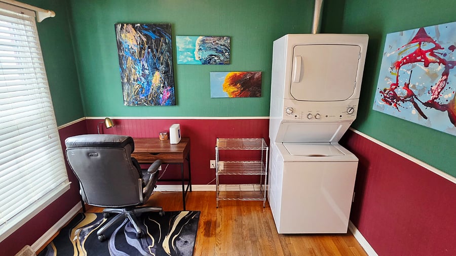 Desk and comfortable chair, as well as full washer/dryer stack.