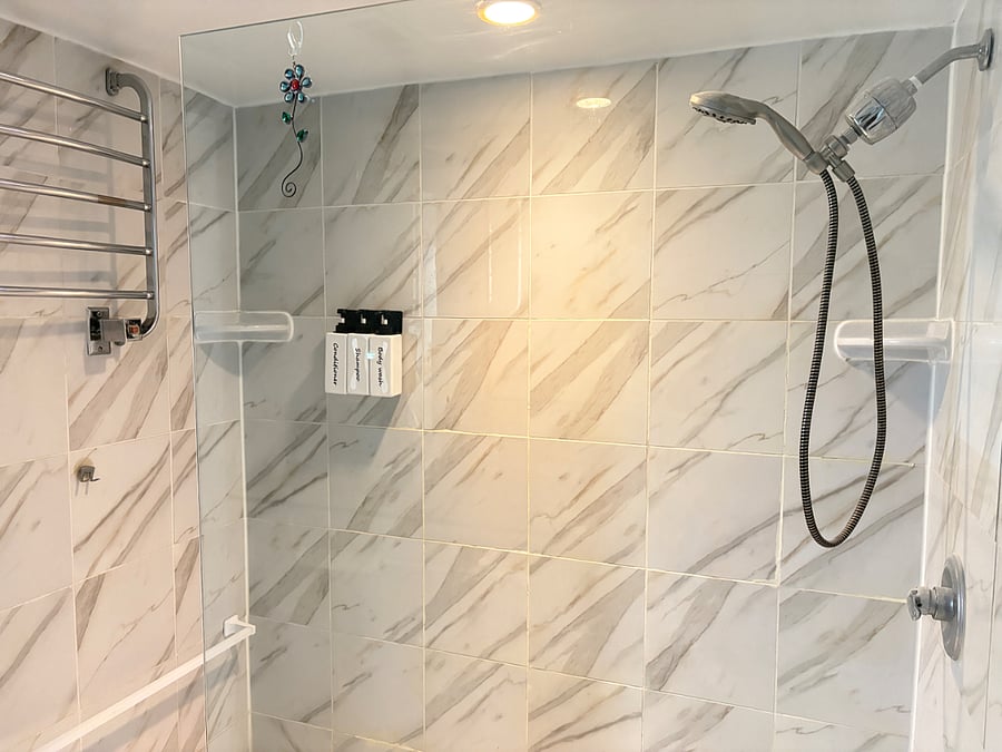 Walk-in shower with heated towel rack