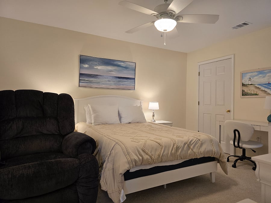 master bedroom with e-z chair and desk