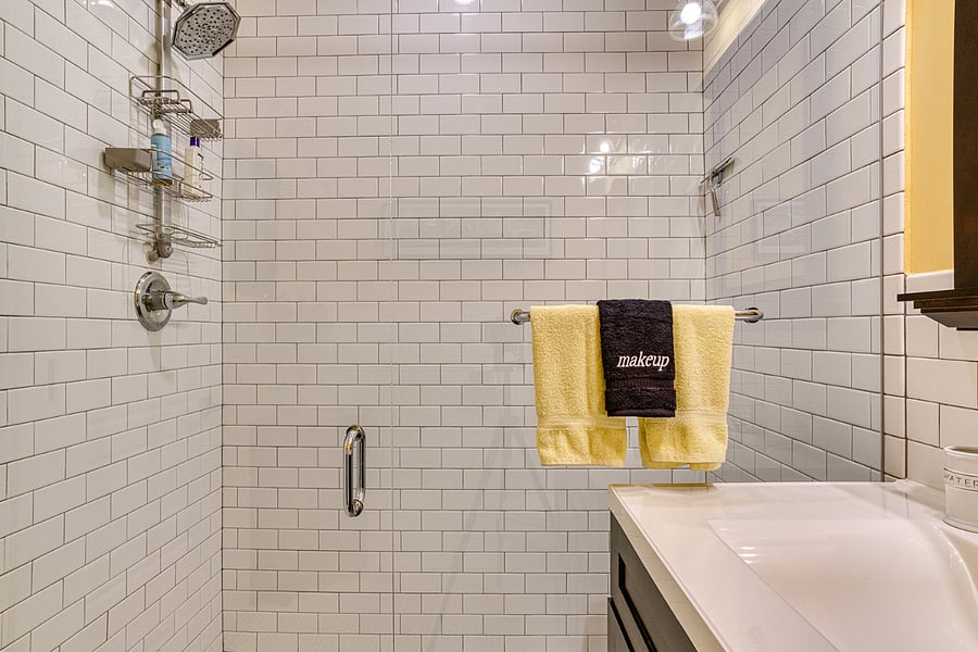 Very large shower (no lip or step) with teak shower chair.
