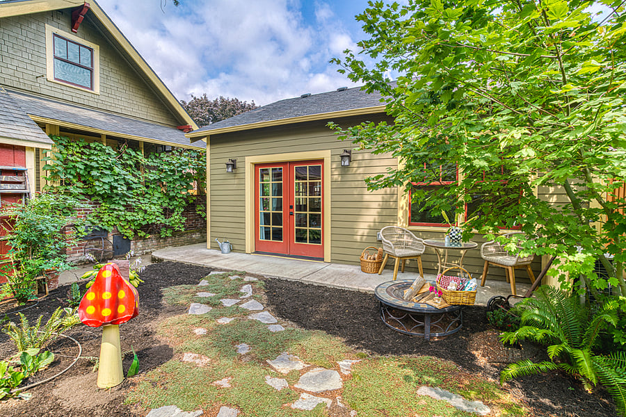 The grapes on the back of the Craftsman create a natural barrier between the two houses.