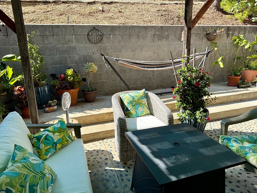 Private back patio with firepit, hammock, and dining table