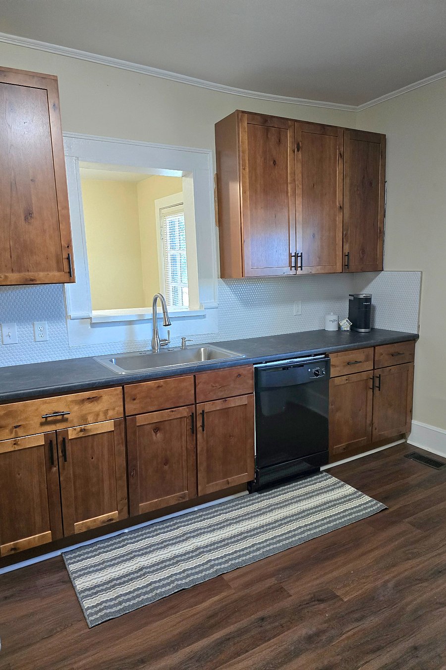 Kitchen with generous cabinet space, dishwasher and large sink