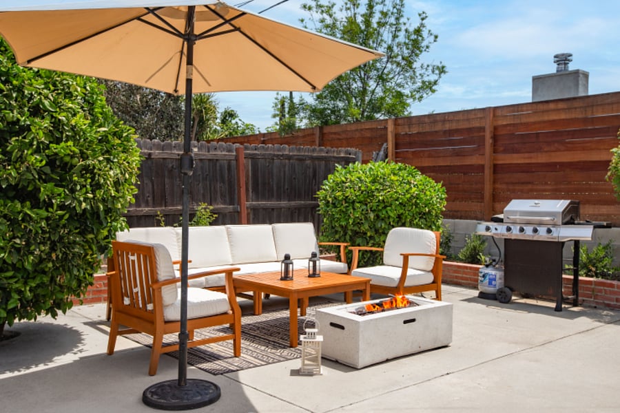 Outdoor seating + fire pit area in fenced private backyard