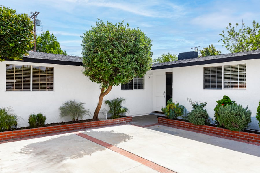 Front exterior and large private driveway parking